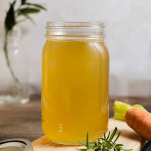 The Instant Pot Chicken Broth is in a large mason jar.