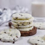 The cookies are stacked on a wooden plate.