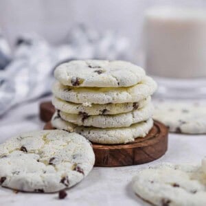 The cookies are stacked on a wooden plate.