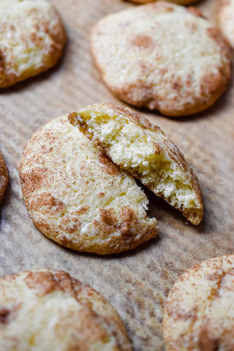 A sourdough snickerdoodle is on a baking sheet cut in half.