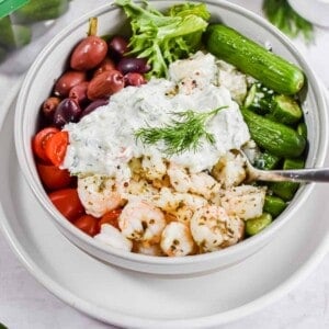 A sprig of dill garnishes the shrimp bowl.