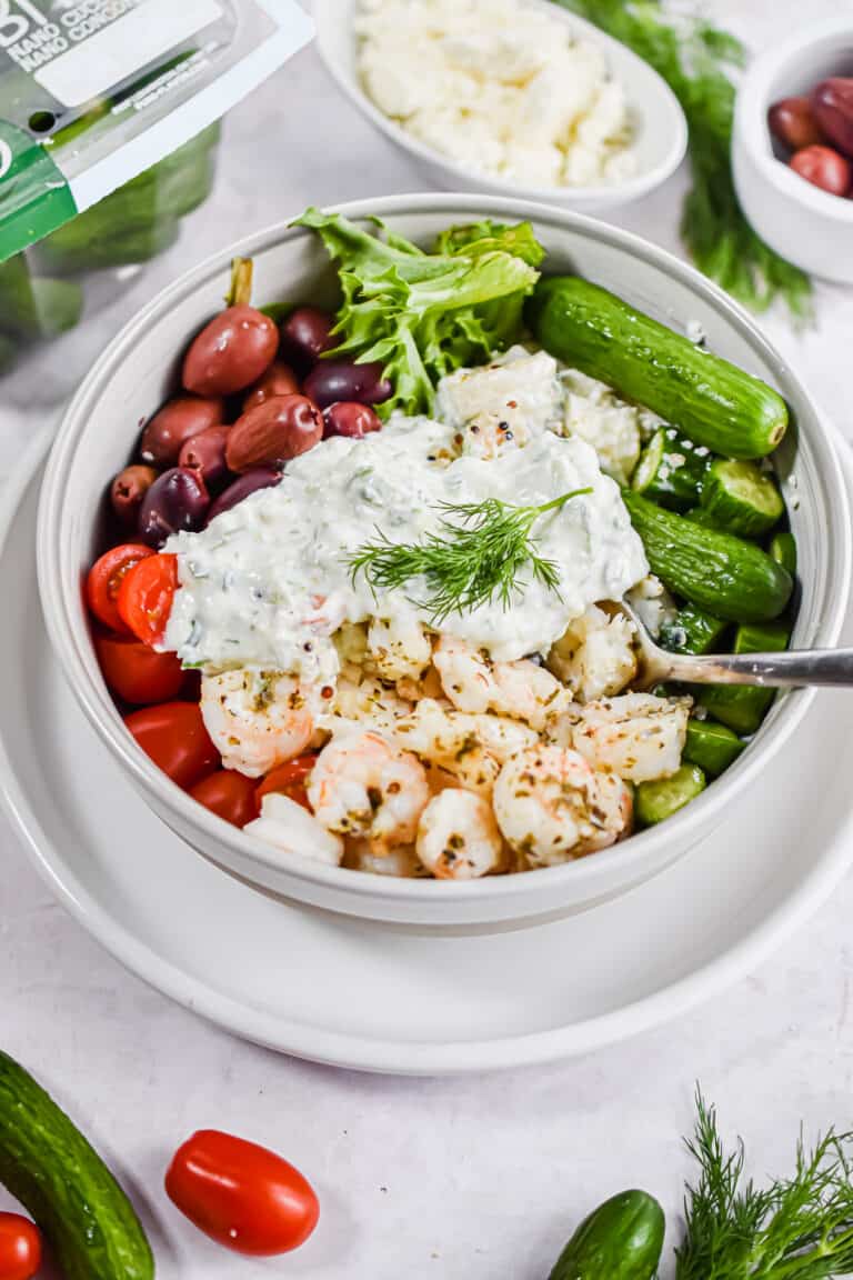 A sprig of dill garnishes the shrimp bowl.