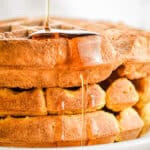 Maple syrup is dripping off the pumpkin waffles.