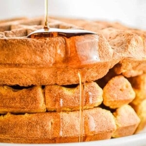 Maple syrup is dripping off the pumpkin waffles.