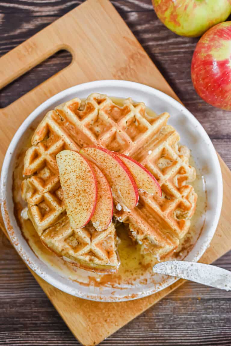 An overhead shot of the waffles topped with sliced apples.