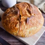 A loaf of bread is on a cutting board.