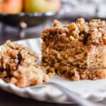 A close up of a slice of cake and a piece on the fork.