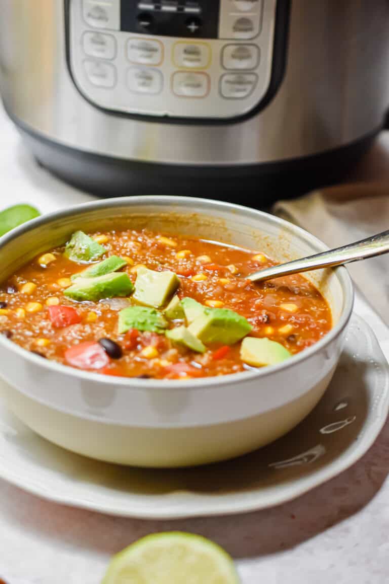 A bowl of soup is in front of the Instant Pot.