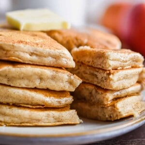 A piece of the applesauce pancakes is cut out of the stack.
