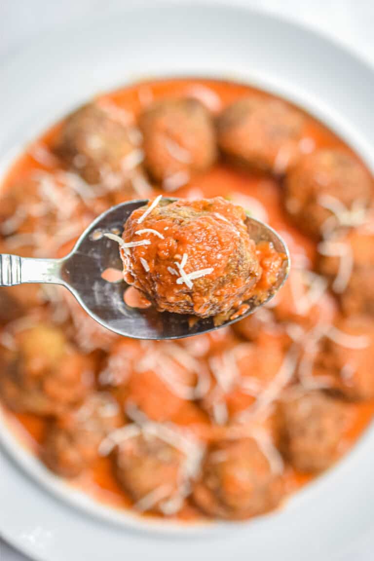 A meatball is in a spoon