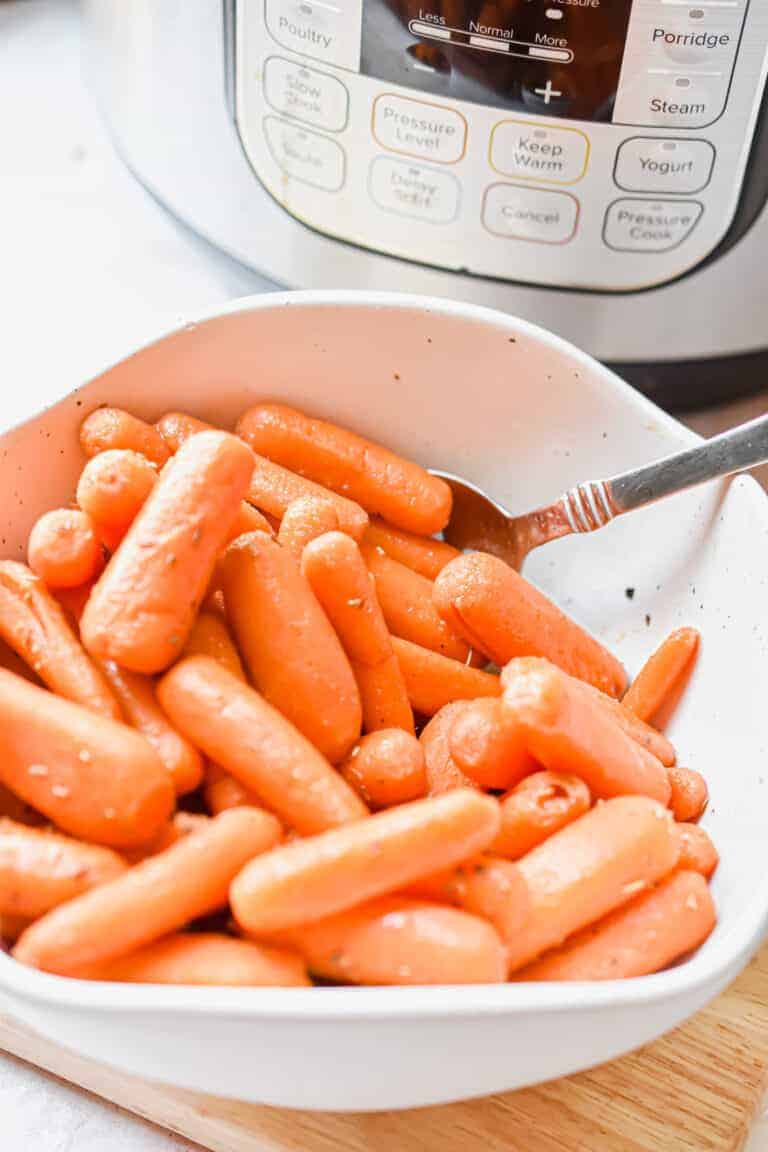 The Instant Pot is behind the bowl of carrots.