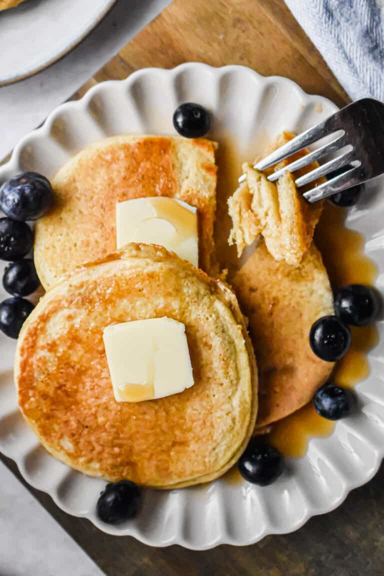 A fork is holding a piece of the pancakes