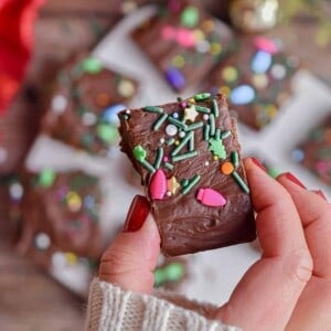 A hand is holding a piece of fudge.