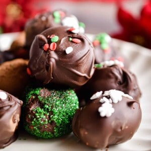 A pile of chocolate truffles on a fluted plate.