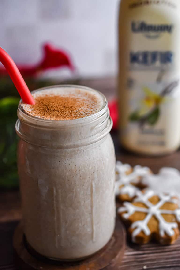 The gingerbread kefir smoothie is in front of the bottle of kefir.
