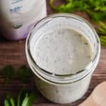 An overhead shot of the ranch dressing with the kefir bottle in the background.