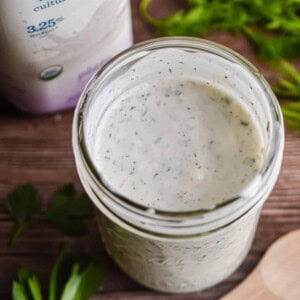 An overhead shot of the ranch dressing with the kefir bottle in the background.