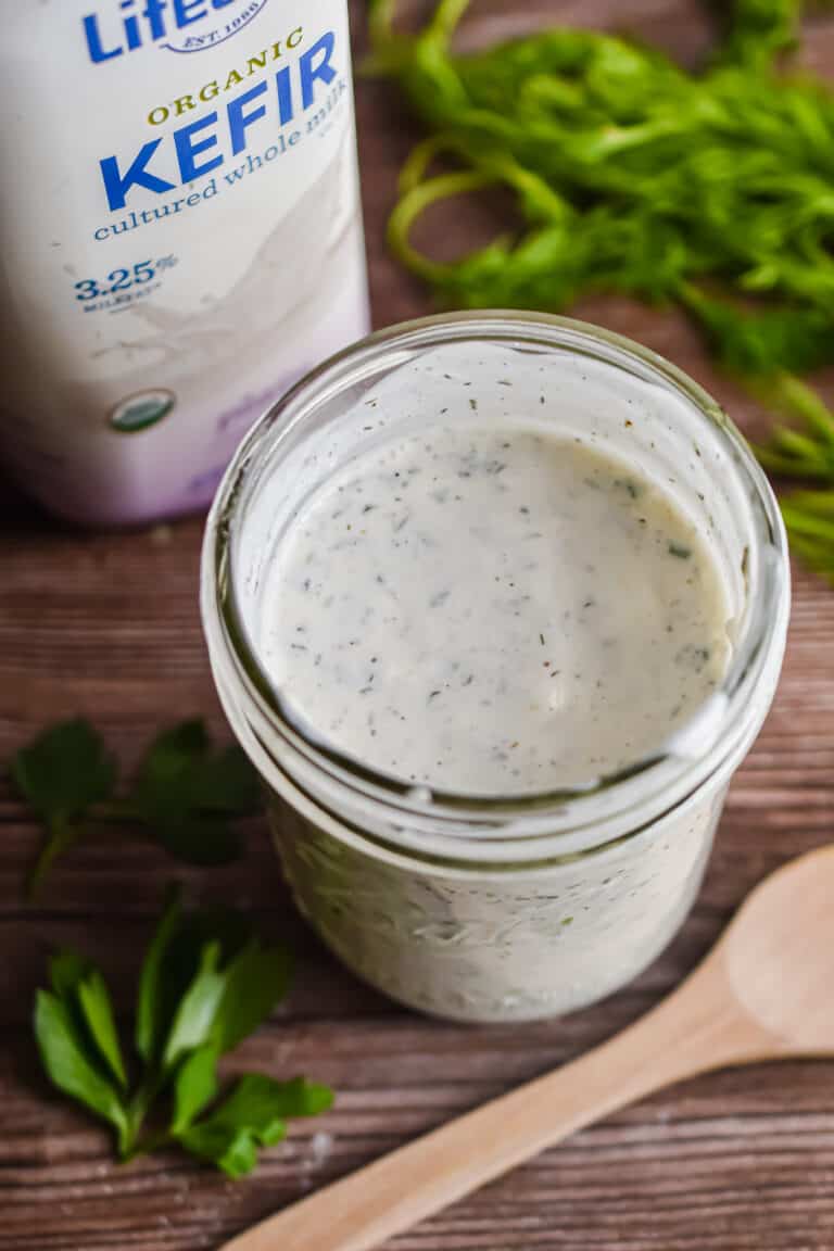 An overhead shot of the ranch dressing with the kefir bottle in the background.