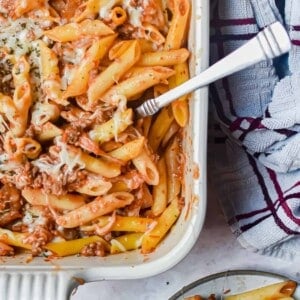 A close of up the meaty marinara in the baking dish and a portion is on a plate.