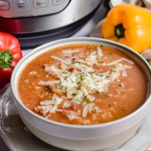 The Instant Pot Stuffed Pepper soup is in front of an instant pot.