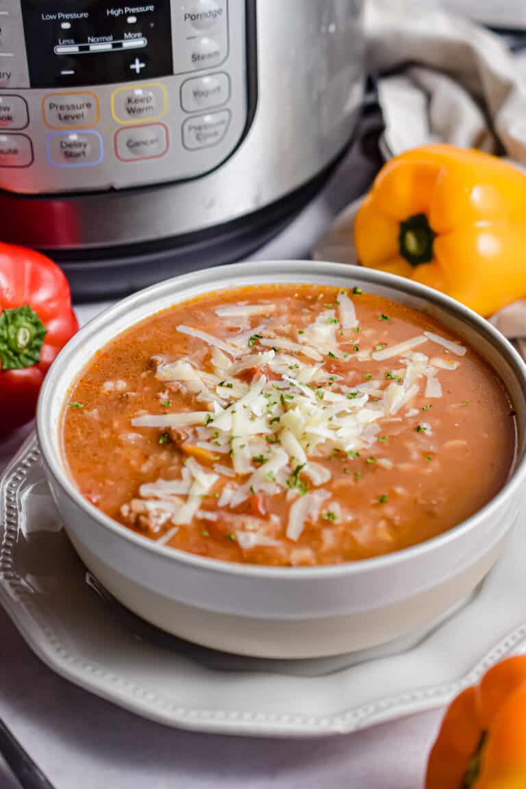 The Instant Pot Stuffed Pepper soup is in front of an instant pot.