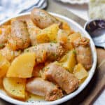 The Instant Pot Sausage and Potatoes are on a plate on a cutting board.
