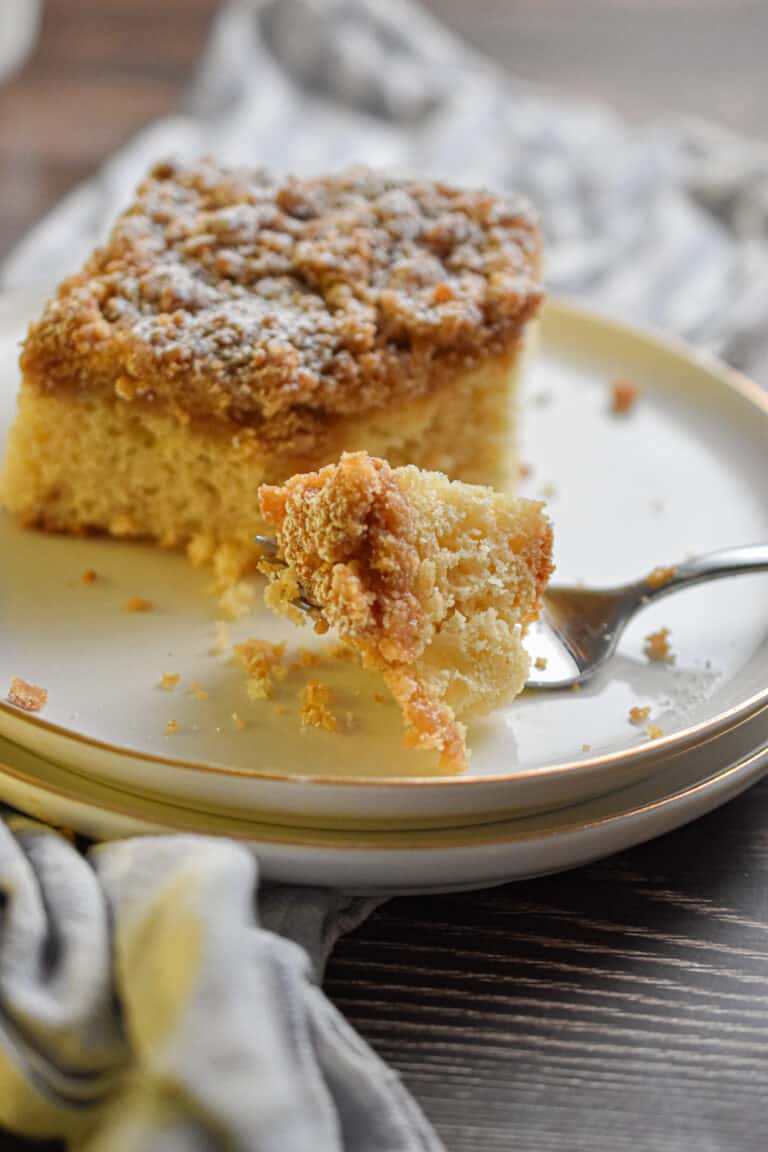 A piece of the Bisquick coffee cake in a 9x13 inch pan is on a fork.