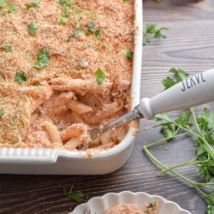A spoon with the word serve on it is in the baking dish.