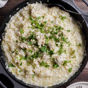 Crab meat and parsley is on top of the crab risotto.