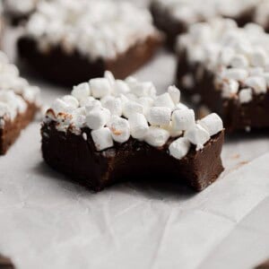 A piece of hot cocoa fudge has a bite out of it.