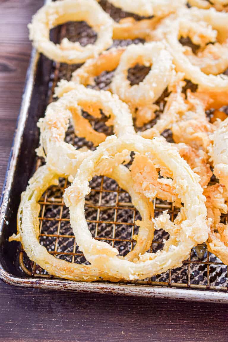 The sourdough discard onion rings are on a baking sheet.