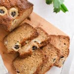 The banana bread with Greek yogurt is cut into 5 pieces on a cutting board.