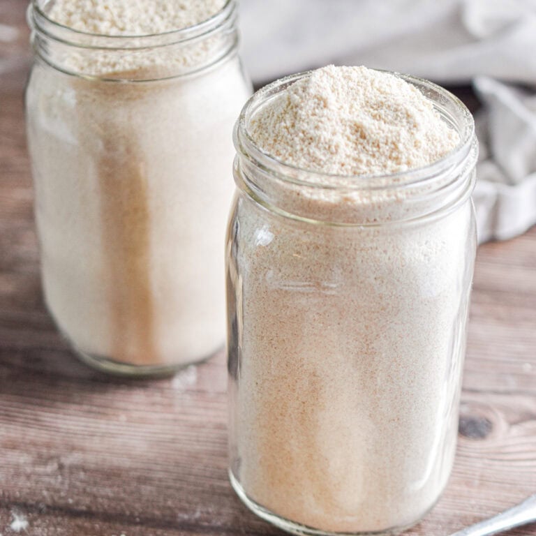 Two mason jars are full of whole wheat baking mixes.