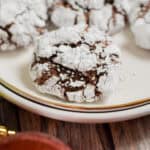 A sourdough chocolate crinkle cookie is on a white plate.