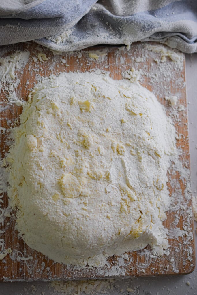 The dough is on a cutting board.