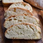 The sliced ciabatta bread are layered together to show the holes in the crumb.