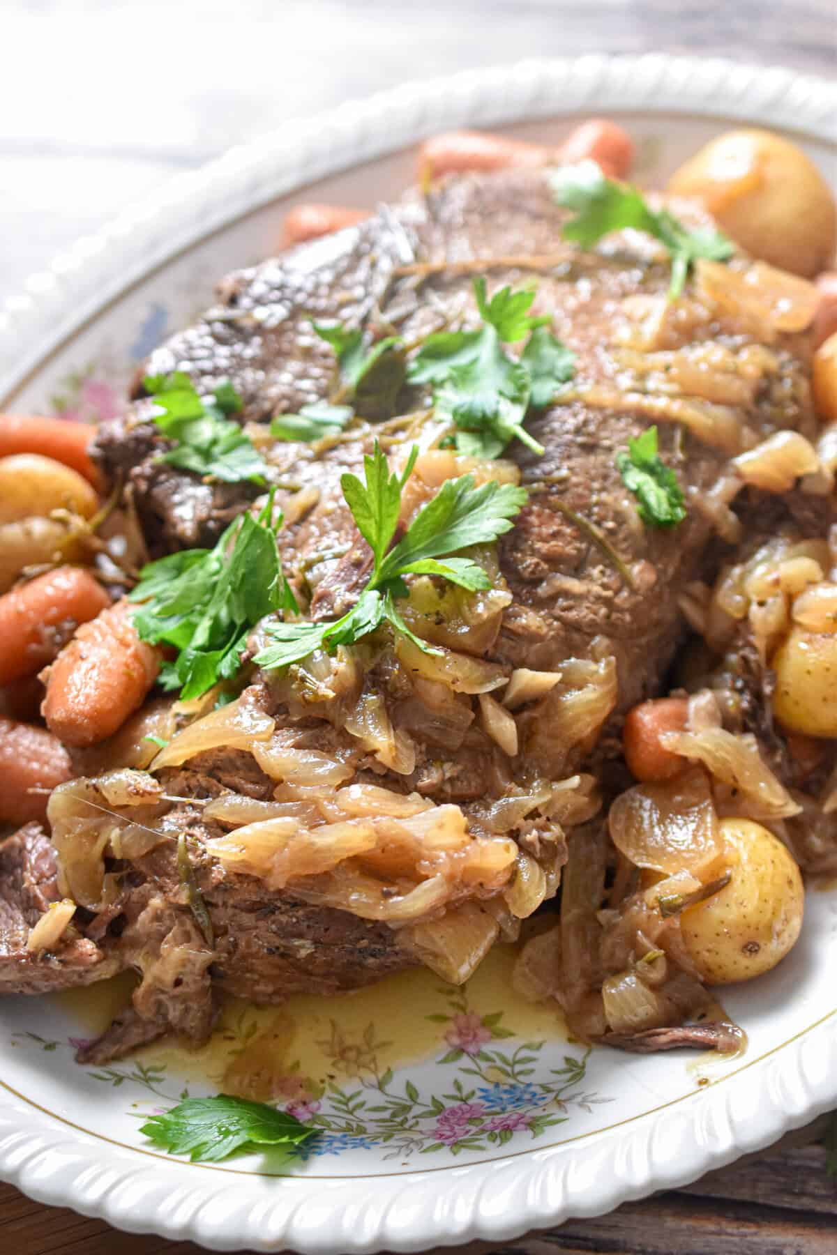 Chopped parsley tops the plate with the meat and vegetables.