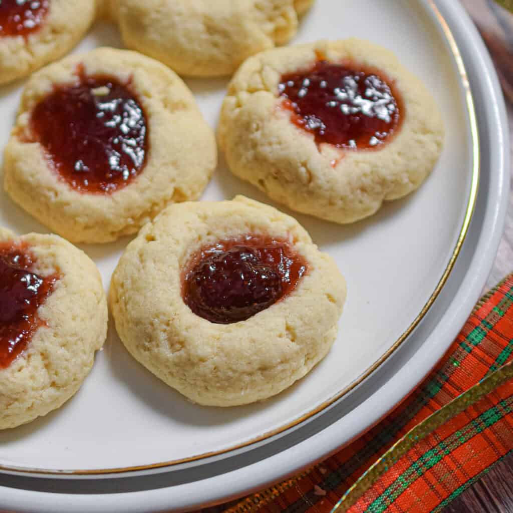 The sourdough thumbprints are on a white plate surrounded by a red plaid bow.