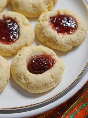 The sourdough thumbprints are on a white plate surrounded by a red plaid bow.
