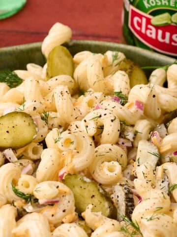 Chopped pickles are added to the top of the dill pickle pasta salad.
