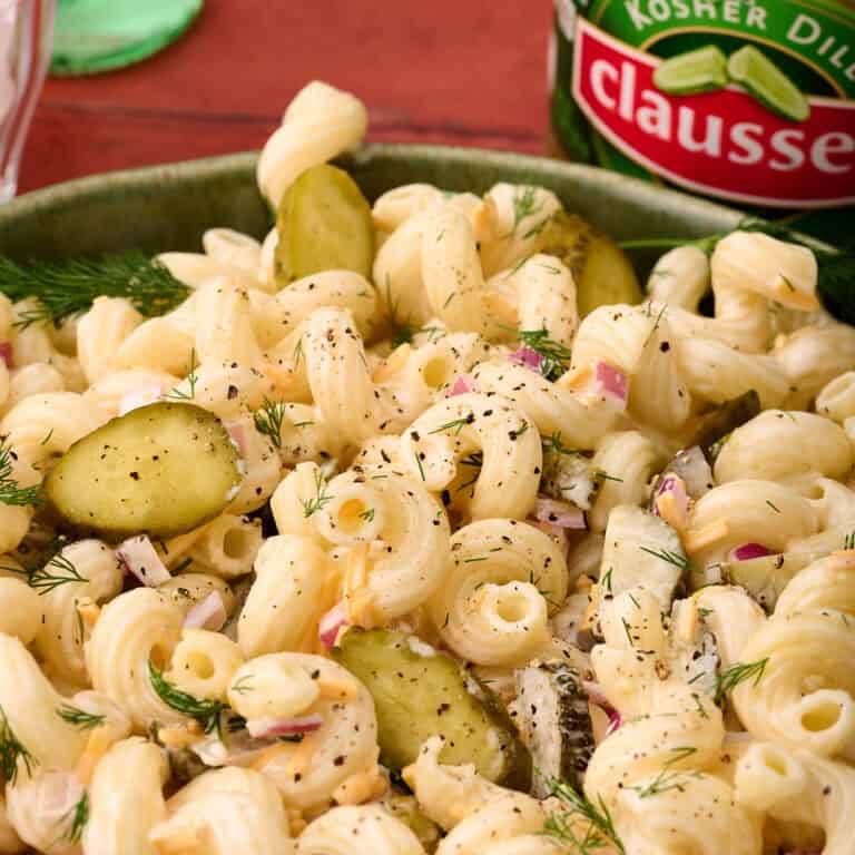 Chopped pickles are added to the top of the dill pickle pasta salad.