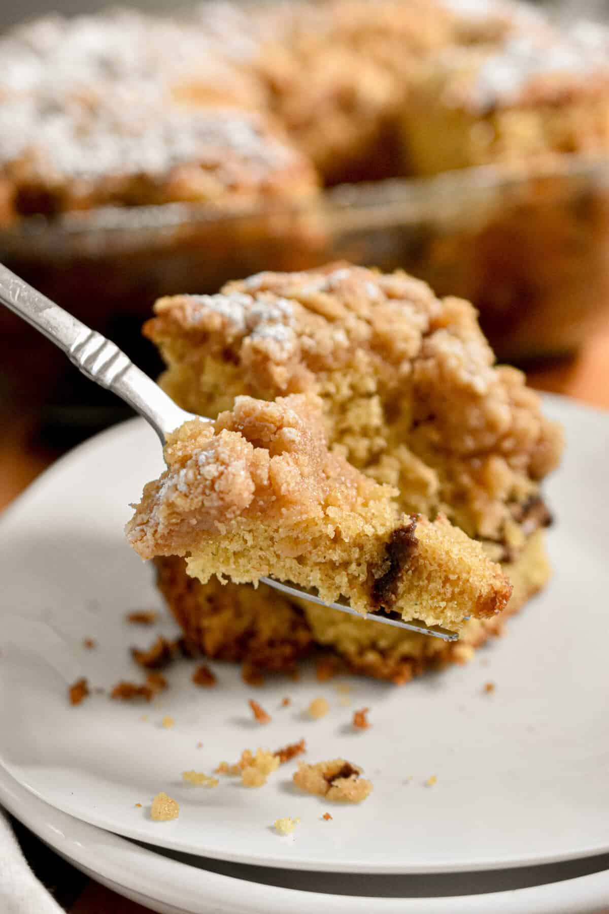 A fork took a piece of the sourdough coffee cake off the plate.