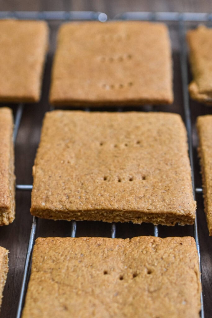 The sourdough graham crackers are on a wire rack.