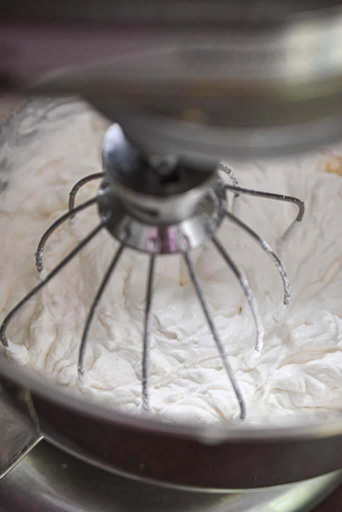 The whipped cream is being made in a stand mixer