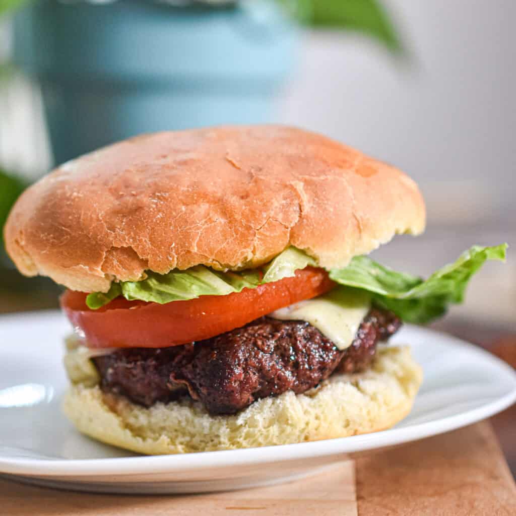 A hamburger is built on a sourdough discard hamburger bun.