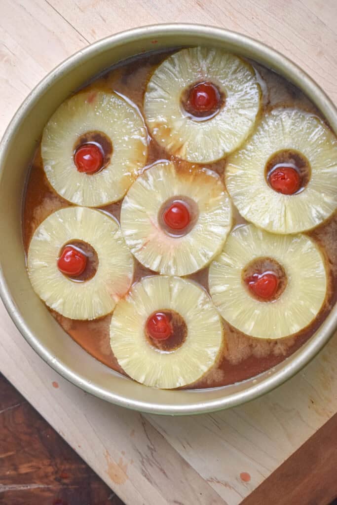 The pineapple rings and cherries are in the caramel.