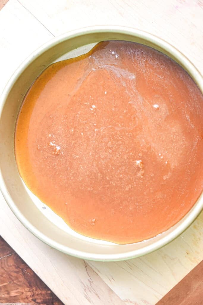The caramel is in a cake pan.