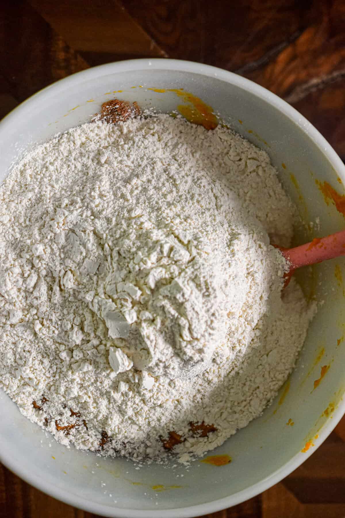 The self rising flour is added to the large mixing bowl.