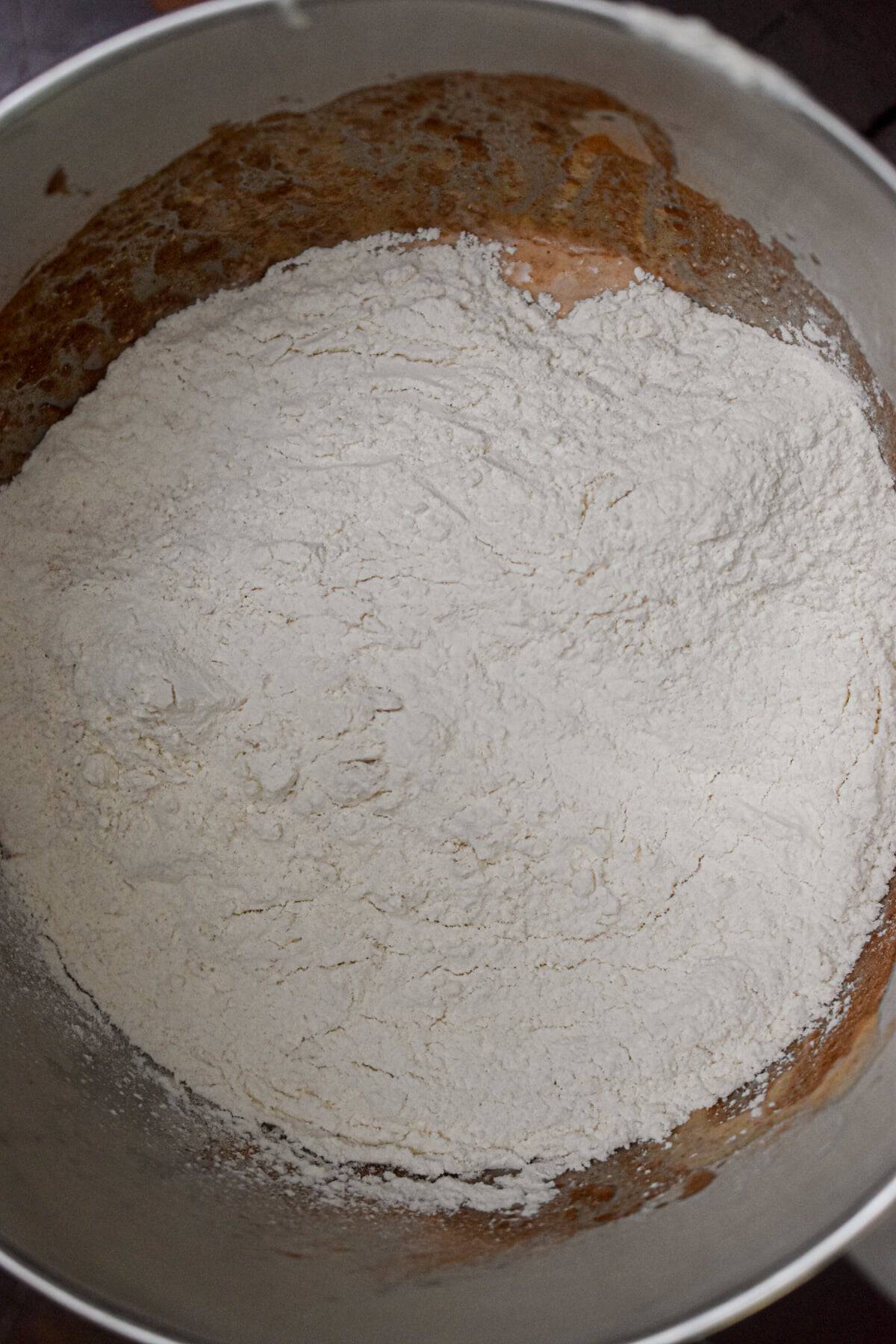 All of the ingredients are in the bowl of a stand mixer.