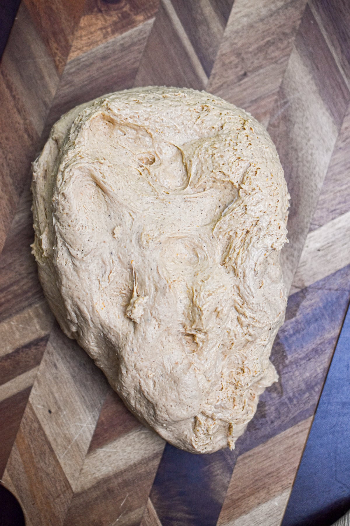 The dough is on a cutting board, fully risen.